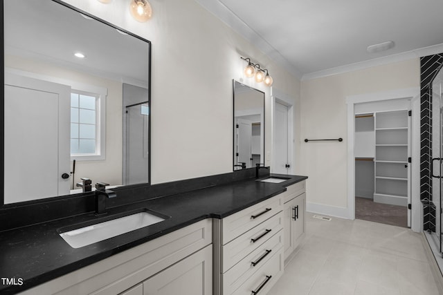 bathroom with dual bowl vanity, ornamental molding, and tile flooring