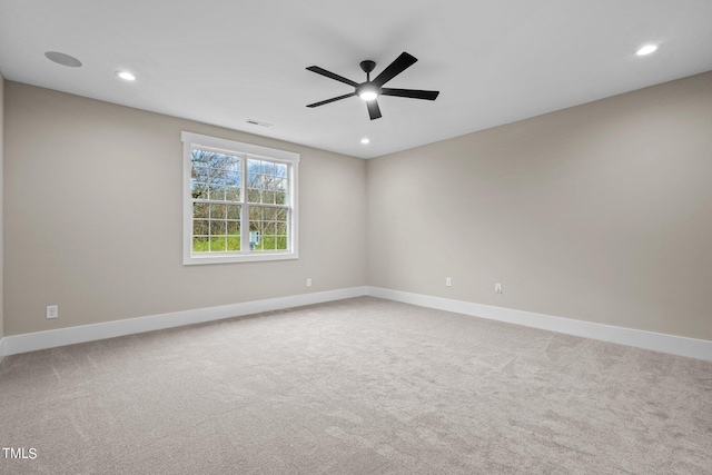 unfurnished room featuring ceiling fan and light colored carpet