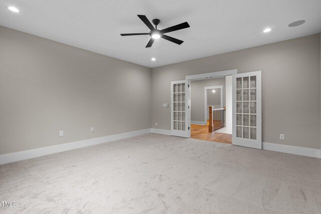 spare room featuring ceiling fan, light wood-type flooring, and french doors