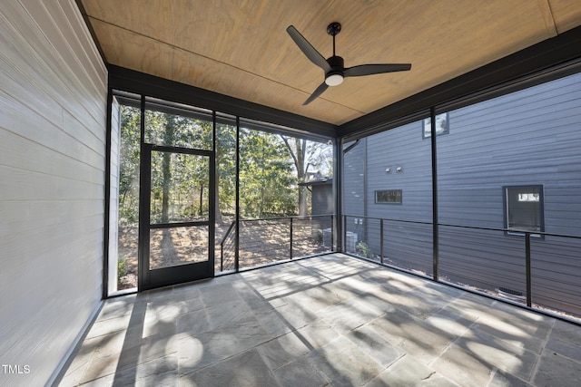 unfurnished sunroom with wooden ceiling and ceiling fan