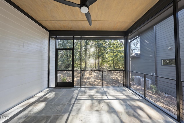 unfurnished sunroom featuring wooden ceiling and ceiling fan