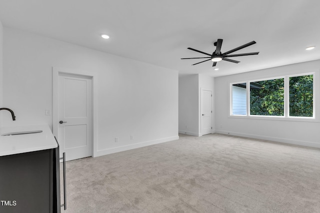 2601 Mayview Rd, Raleigh, NC 27607 - unfurnished living room with a ceiling fan, recessed lighting, light carpet, and a sink