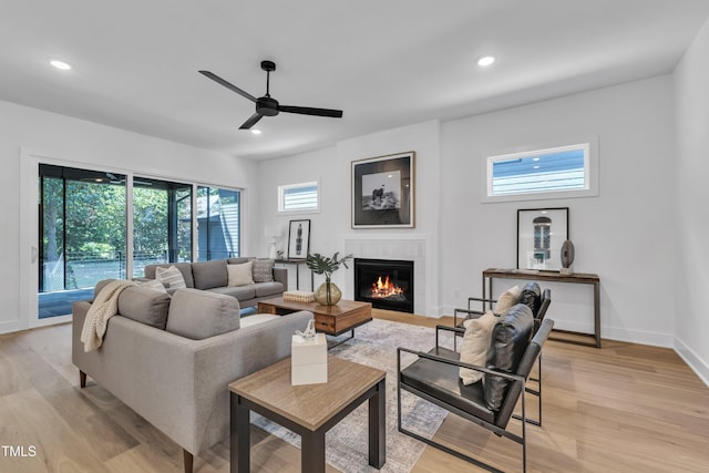 2601 Mayview Rd, Raleigh, NC 27607 - living area with a glass covered fireplace, a ceiling fan, light wood-type flooring, and a wealth of natural light
