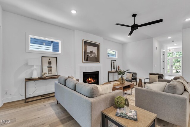 2601 Mayview Rd, Raleigh, NC 27607 - living room featuring visible vents, light wood-style floors, recessed lighting, a tiled fireplace, and a ceiling fan