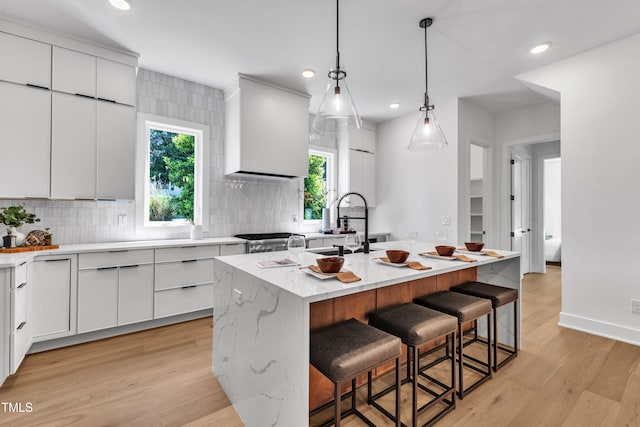 2601 Mayview Rd, Raleigh, NC 27607 - kitchen with white cabinets, an island with sink, modern cabinets, and a kitchen bar