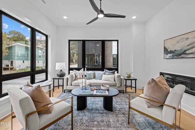 living room with hardwood / wood-style floors and ceiling fan