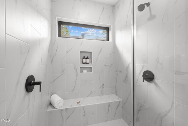 bathroom with a tile shower