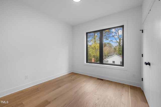 spare room featuring light hardwood / wood-style flooring