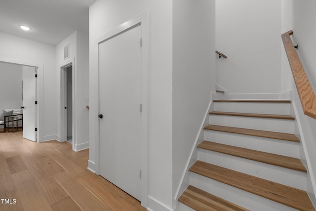 stairs with hardwood / wood-style floors