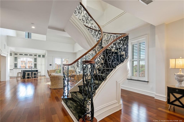 stairway with hardwood / wood-style flooring and plenty of natural light