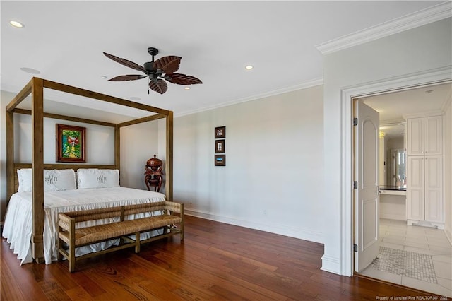 bedroom featuring wood-type flooring, crown molding, ensuite bathroom, and ceiling fan