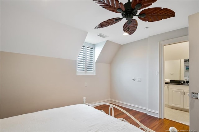 bedroom with ceiling fan, hardwood / wood-style flooring, connected bathroom, and sink