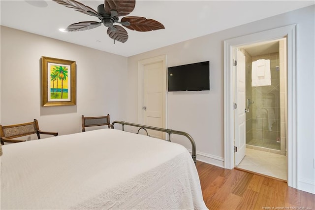 bedroom with hardwood / wood-style floors, ensuite bathroom, and ceiling fan