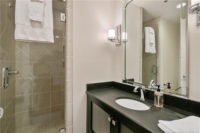 bathroom with walk in shower and vanity