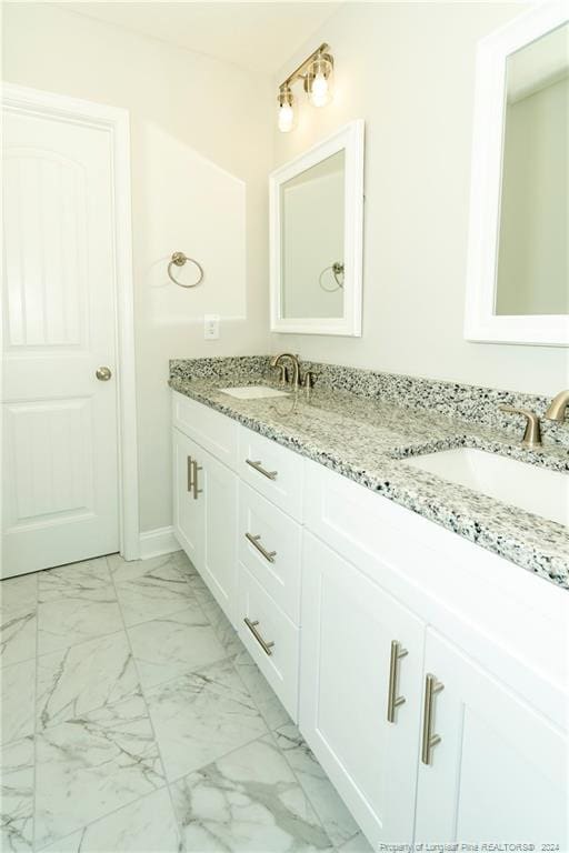 bathroom with dual sinks, tile floors, and oversized vanity