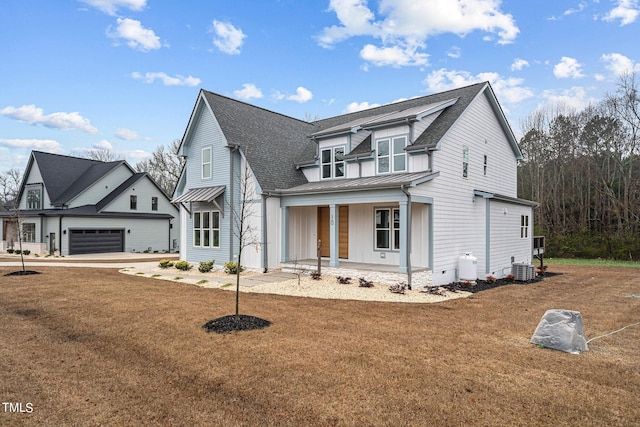 view of front facade featuring a porch, central AC, and a front lawn