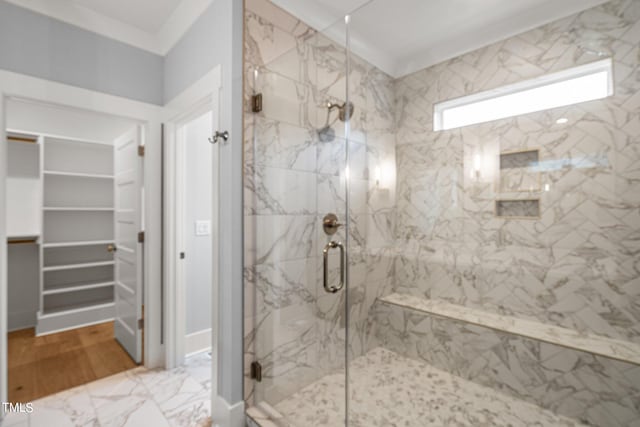 bathroom featuring tile floors, a shower with shower door, and crown molding