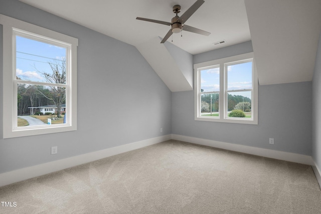 additional living space with vaulted ceiling, carpet flooring, and ceiling fan