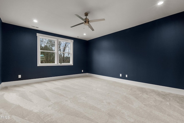 spare room with light carpet and ceiling fan