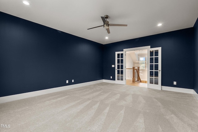 carpeted empty room with french doors and ceiling fan