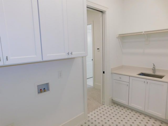 laundry area featuring cabinets, hookup for a washing machine, and sink