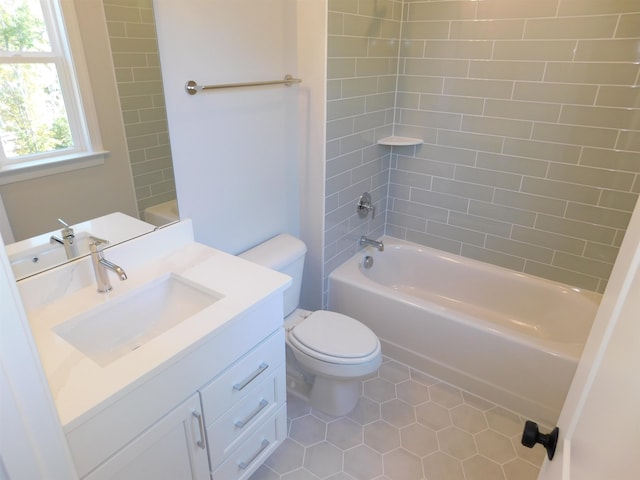 full bathroom with tiled shower / bath, vanity, toilet, and tile patterned floors