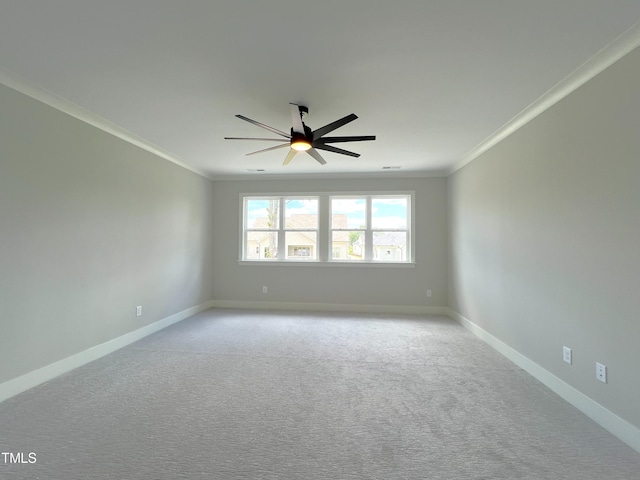 spare room featuring ornamental molding, light carpet, and ceiling fan