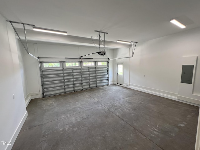 garage with a garage door opener and electric panel