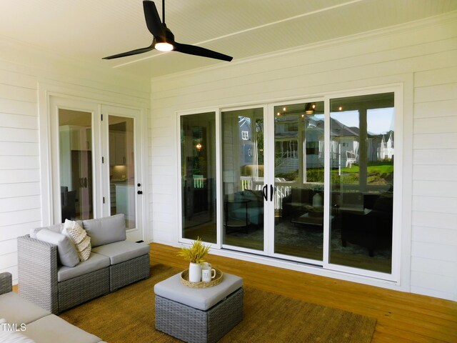 unfurnished sunroom with ceiling fan