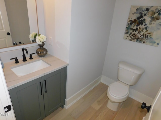 bathroom with vanity, hardwood / wood-style floors, and toilet