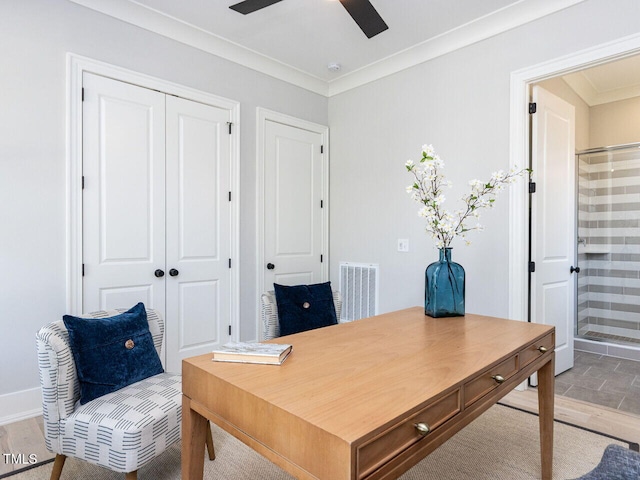 office with crown molding, visible vents, light wood-style floors, ceiling fan, and baseboards