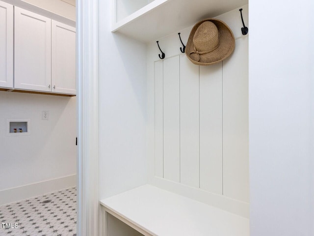 mudroom with light floors and baseboards