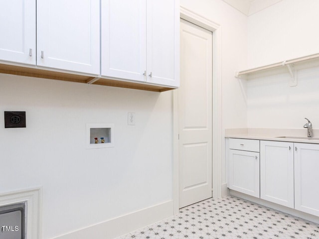 clothes washing area with cabinet space, a sink, hookup for a washing machine, light floors, and electric dryer hookup