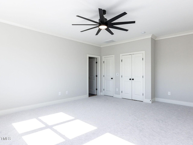 unfurnished bedroom featuring baseboards, carpet floors, and crown molding