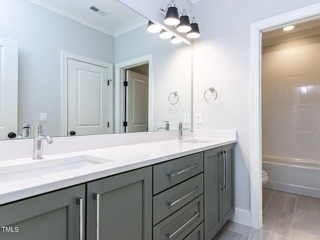 full bath featuring double vanity, ornamental molding, a sink, and visible vents