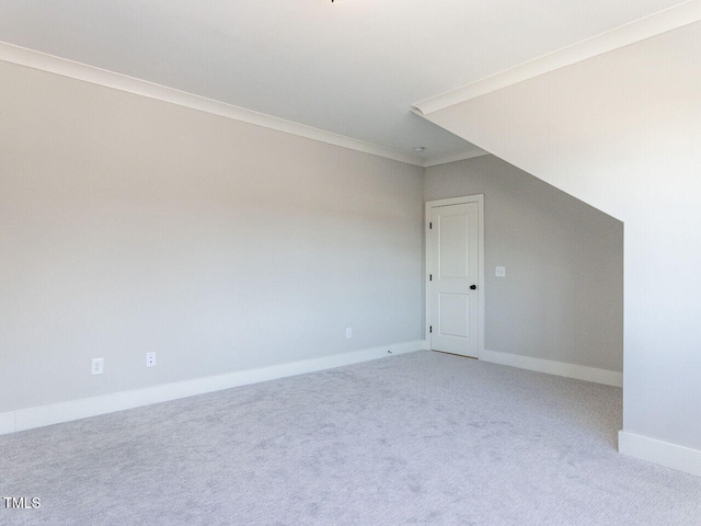 bonus room featuring light carpet and baseboards