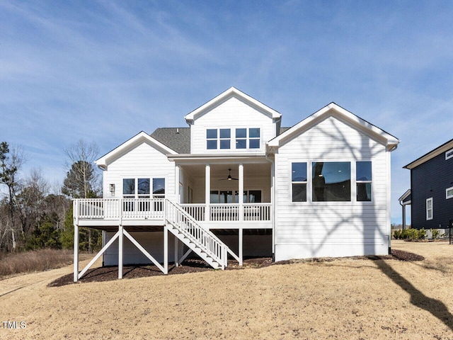 rear view of property featuring stairway, a deck, and a ceiling fan