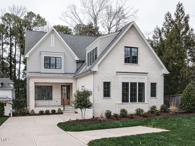 view of front of house with covered porch and a front yard