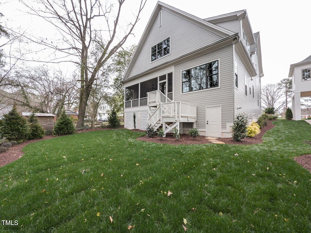 view of front facade with a front yard and a sunroom