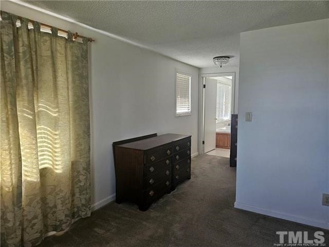 carpeted bedroom featuring a textured ceiling