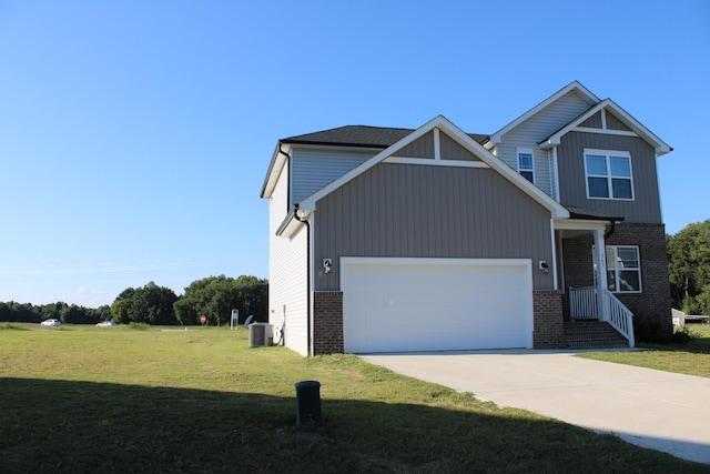 view of front facade featuring a front lawn, central AC, and a garage