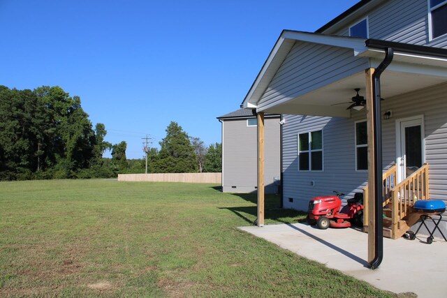 view of yard featuring a patio area and ceiling fan