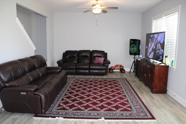 living room featuring ceiling fan and light wood-type flooring