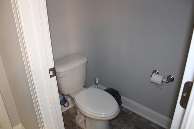 bathroom featuring tile floors and toilet