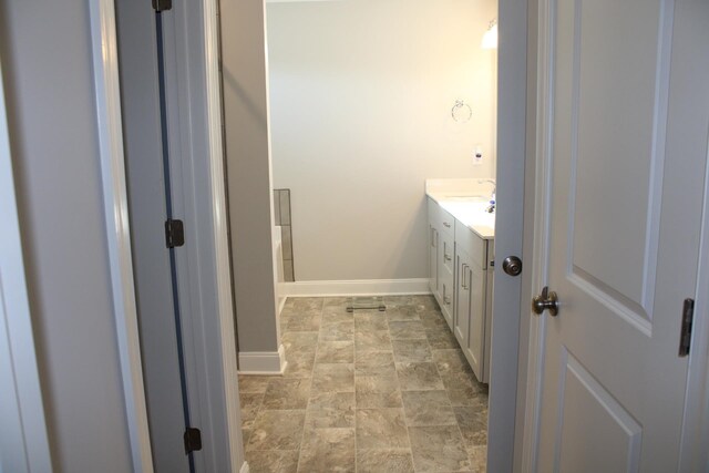 bathroom with tile floors and vanity