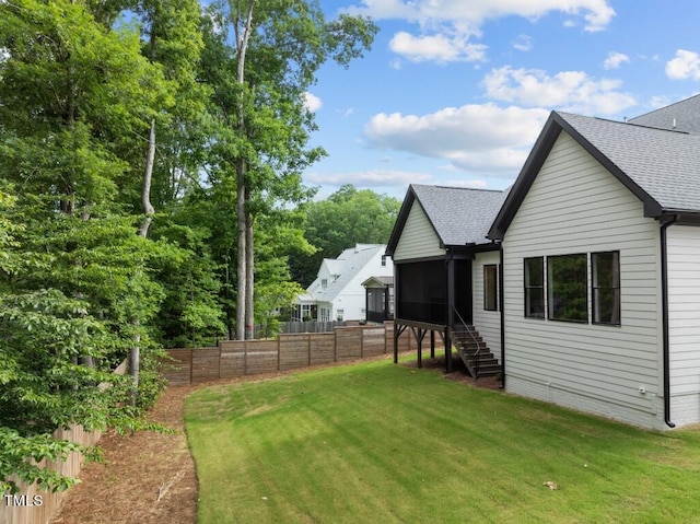 exterior space with a lawn and a sunroom