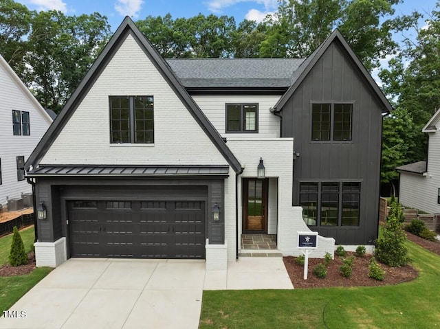 modern inspired farmhouse featuring a garage, central air condition unit, and a front yard