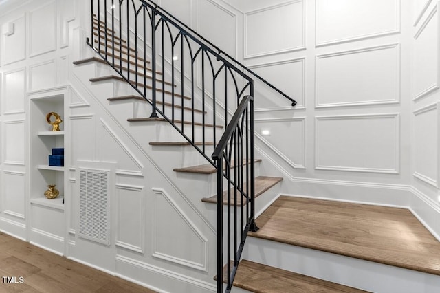 stairway with hardwood / wood-style flooring