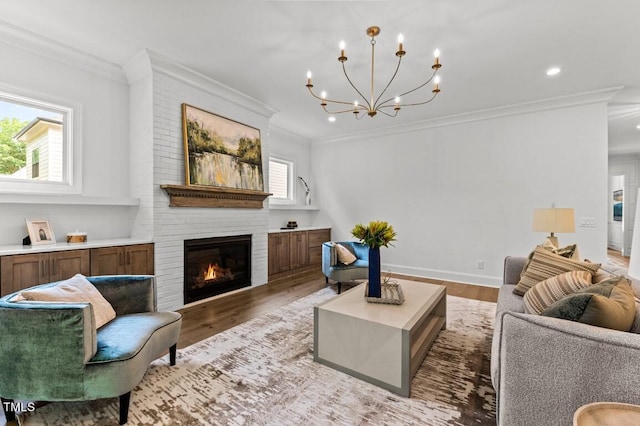 living room with a fireplace, light hardwood / wood-style floors, and ornamental molding