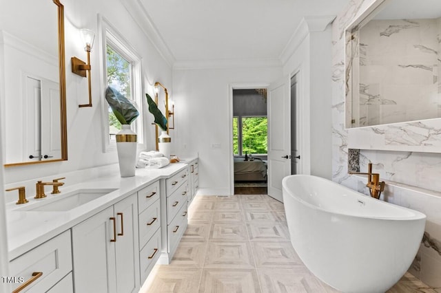 bathroom featuring vanity, a tub to relax in, and crown molding